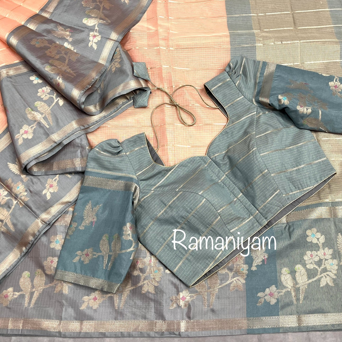 Pastel peach Kota saree with contrast grey border with parrot motifs