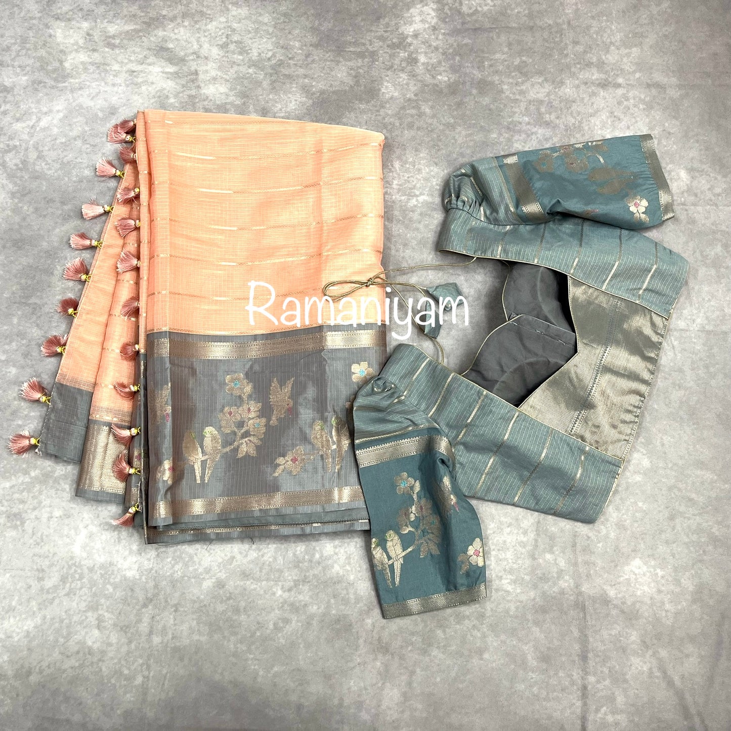 Pastel peach Kota saree with contrast grey border with parrot motifs
