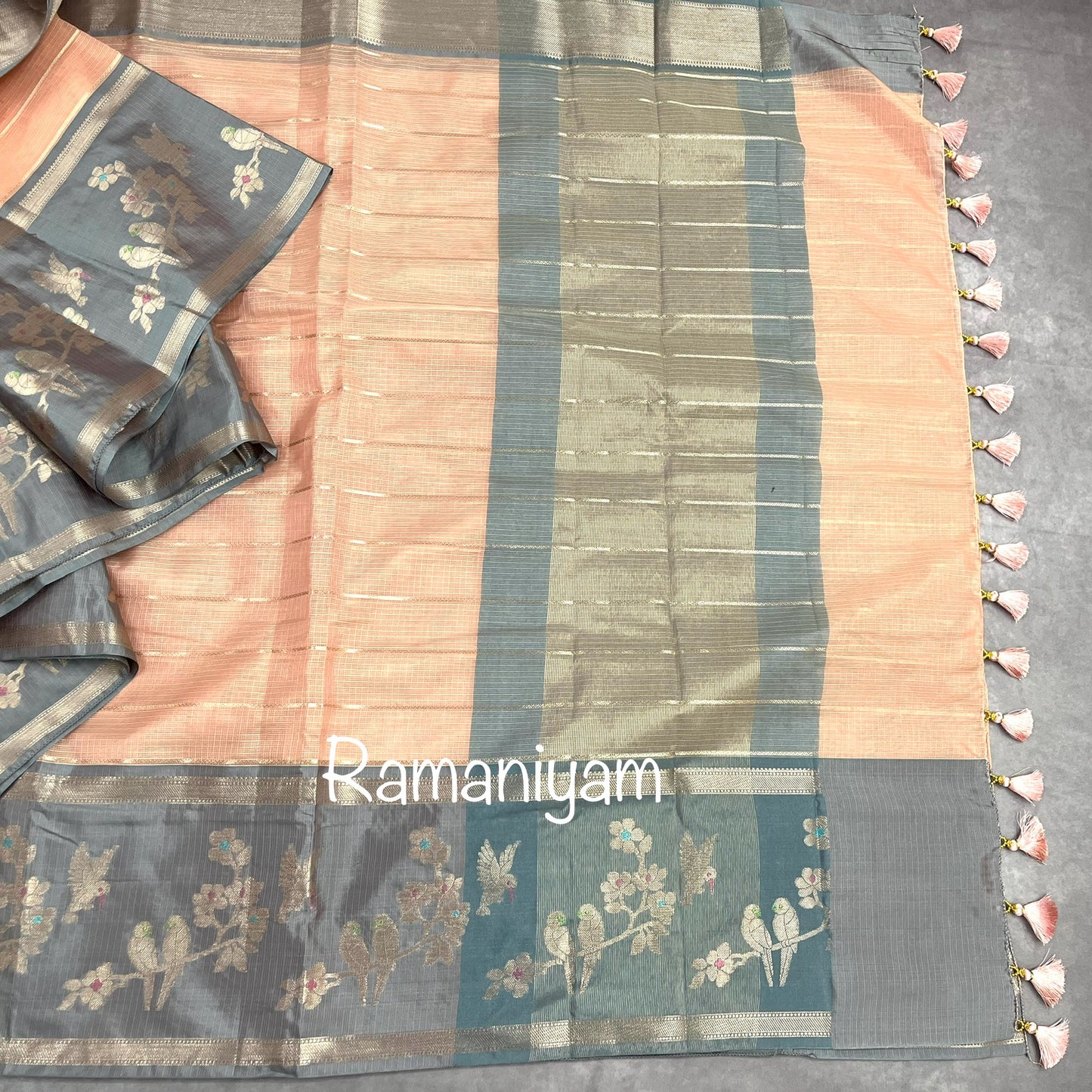 Pastel peach Kota saree with contrast grey border with parrot motifs