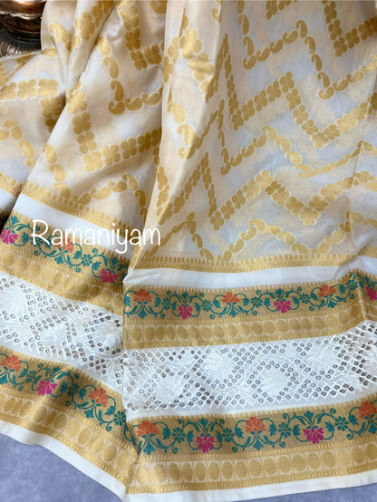 Off-white Banarasi saree adorned with mesmerizing meenakari and cutwork border