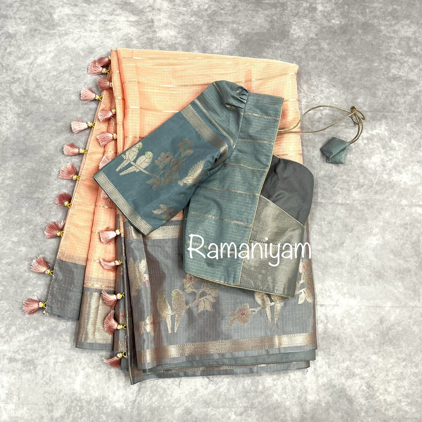 Pastel peach Kota saree with contrast grey border with parrot motifs