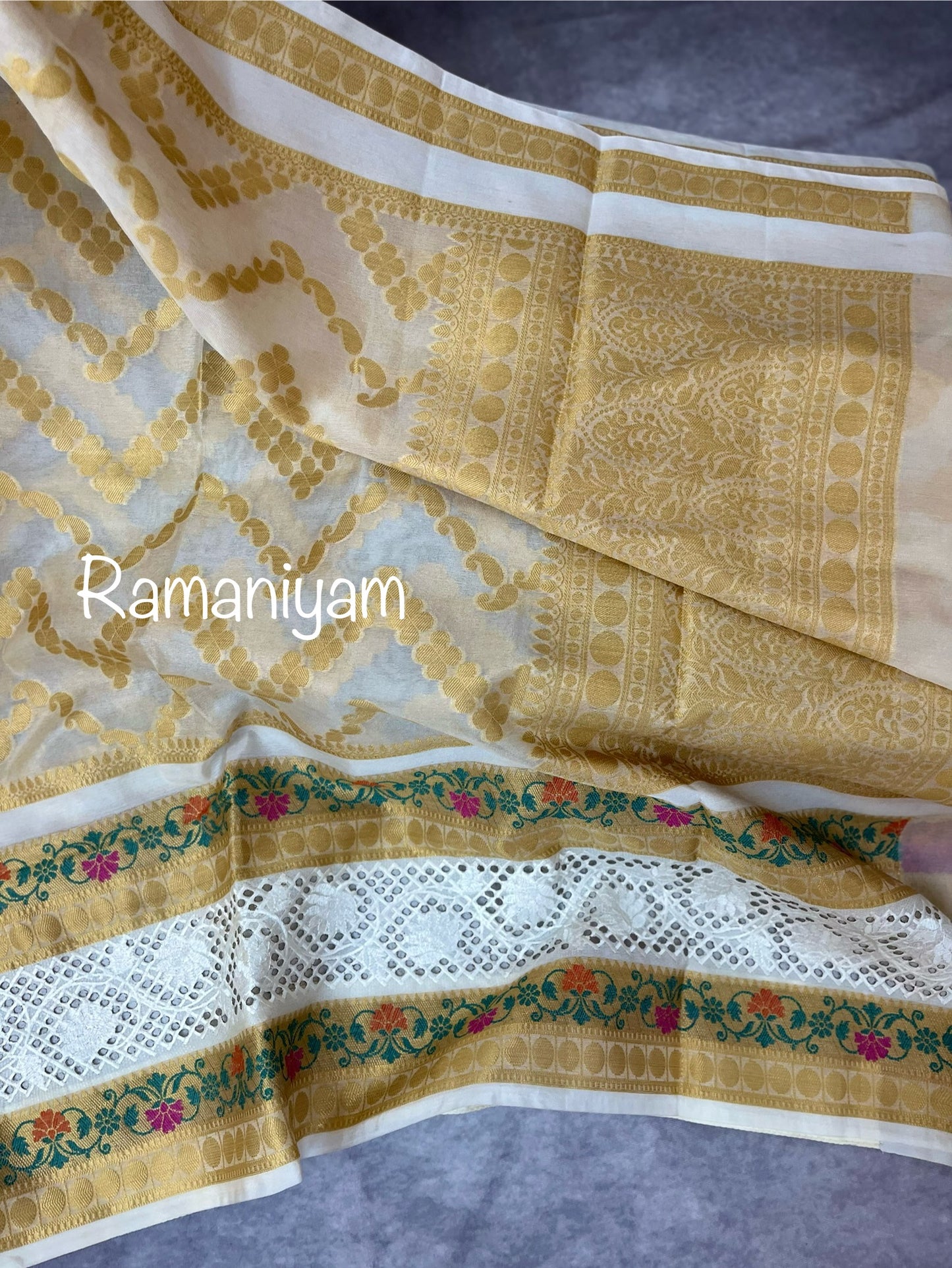 Off-white Banarasi saree adorned with mesmerizing meenakari and cutwork border