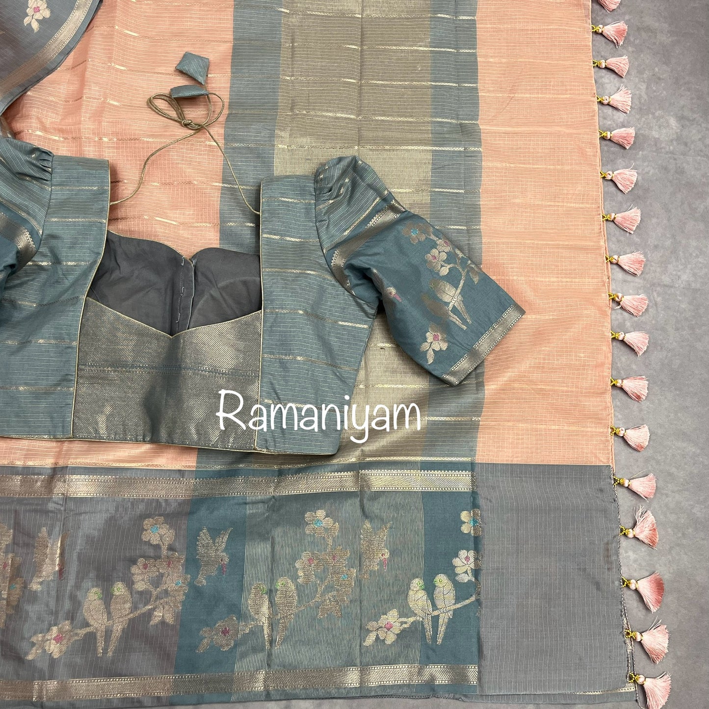 Pastel peach Kota saree with contrast grey border with parrot motifs